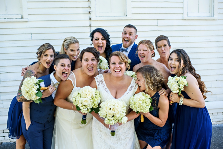 An excited LGBTQ wedding party scream for joy.